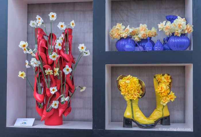 View a framed artwork of flowers and shoes
