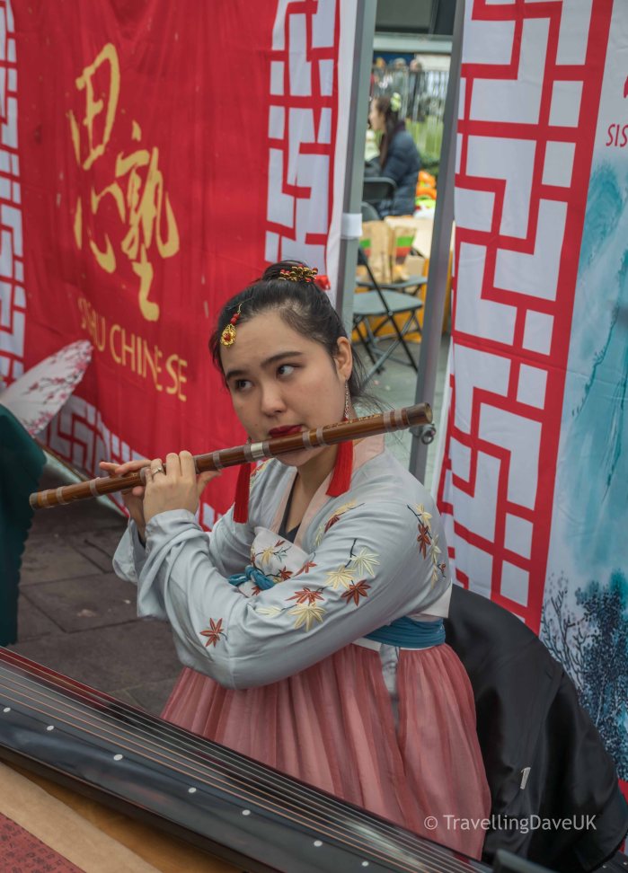 A young musician entertaining the crowds at Chinese New Year celebration